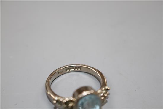 A modern 18ct white gold, aquamarine and marcasite set dress ring, size N, gross weight 5.8 grams.